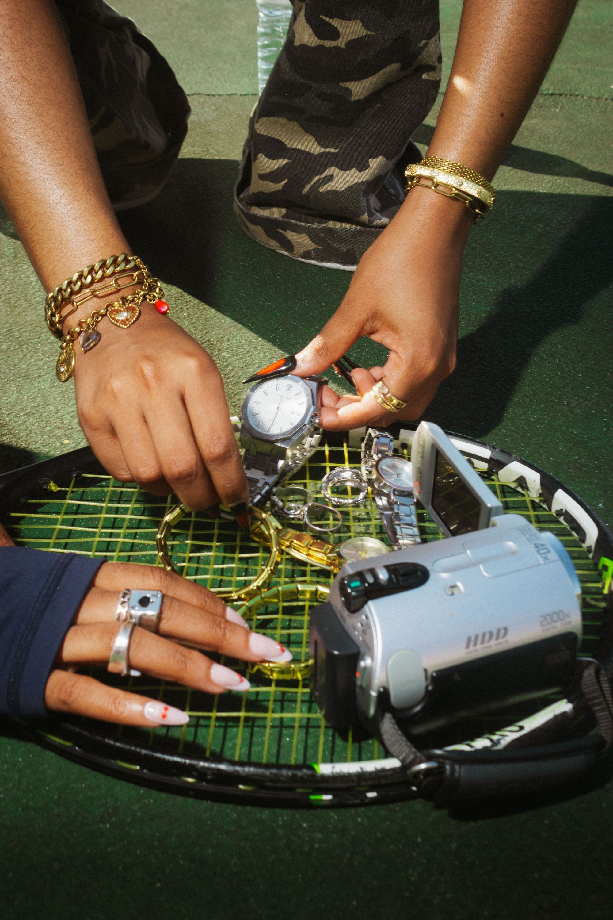Hands stacked with NEUXJEWELS bracelets and watches